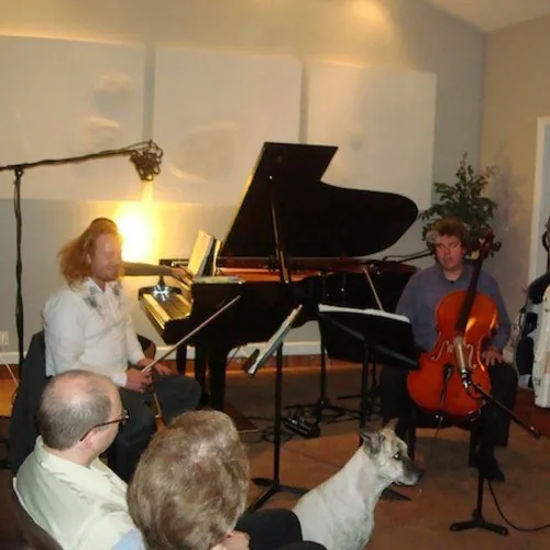 Pianist and cellist performing for a seated audience in the Hit Warehouse session archive