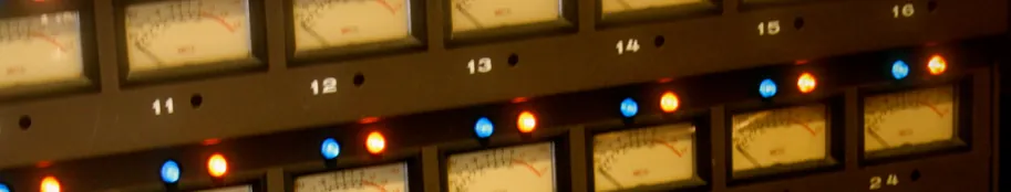 Illuminated analog VU meters showing recording levels in the Hit Warehouse control room